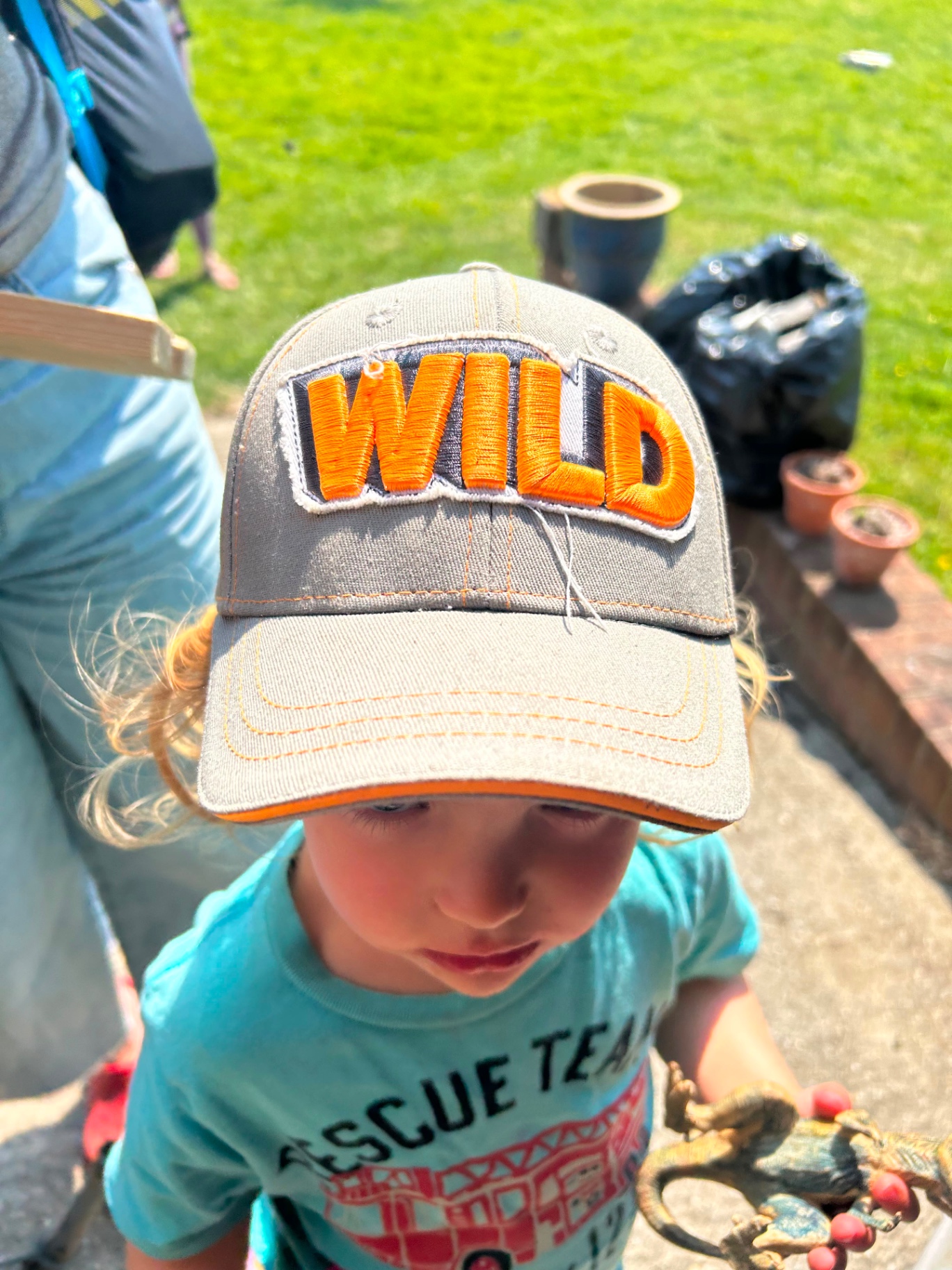A child wearing a cap with WILD embroidered on it