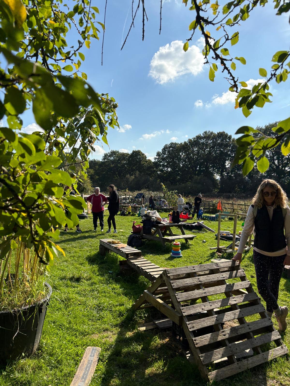 The field in autumn sunshine with pallet dens and picnic benches